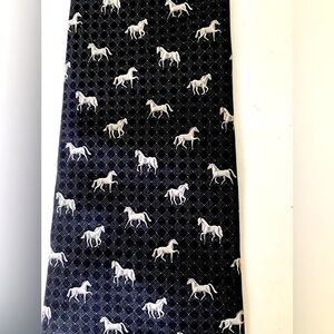 Men’s 100% silk black neck tie with a pattern of light greyishwhite color horses